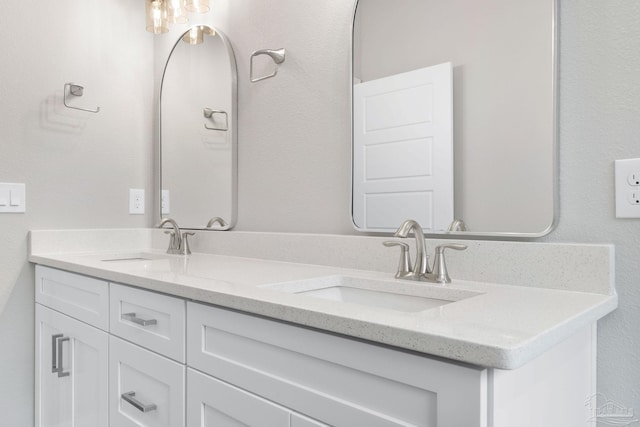 full bathroom featuring double vanity and a sink