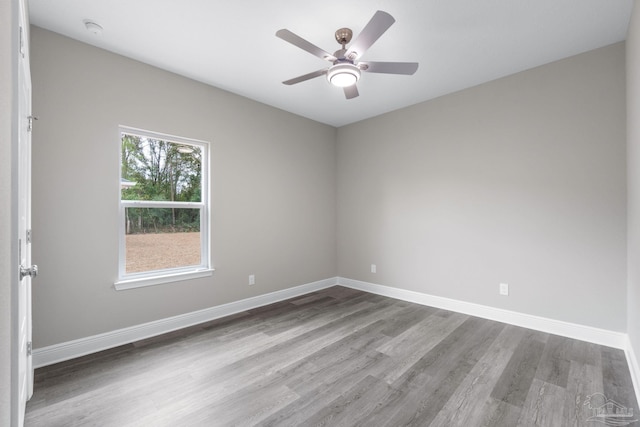 unfurnished room with ceiling fan, baseboards, and wood finished floors