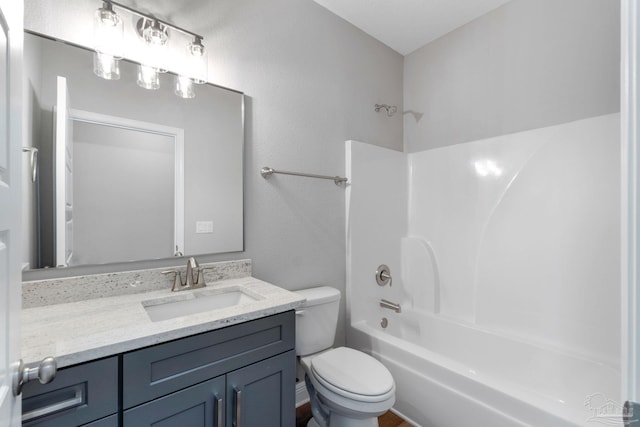 full bath featuring toilet, vanity, and  shower combination