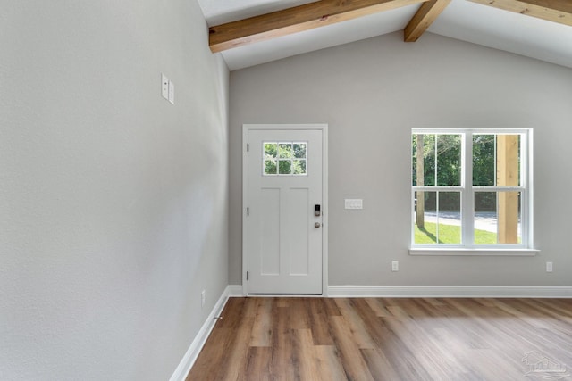 entryway with lofted ceiling with beams, baseboards, and wood finished floors