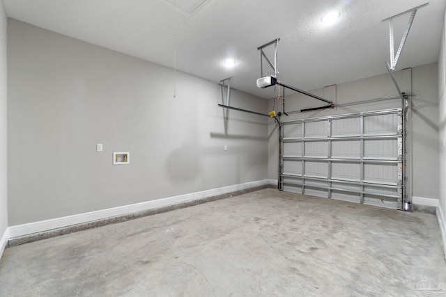 garage featuring a garage door opener and baseboards