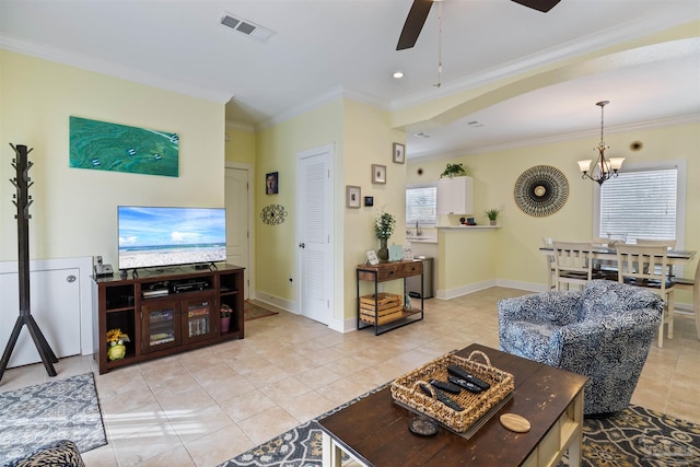 living room featuring crown molding, ceiling fan with notable chandelier, sink, and light tile patterned floors