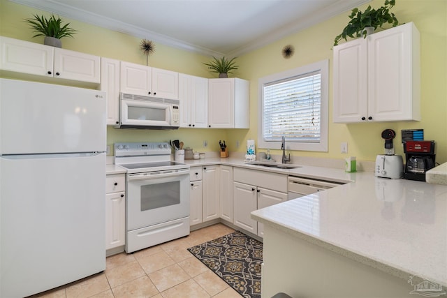 kitchen with sink, white appliances, light tile patterned floors, ornamental molding, and white cabinets