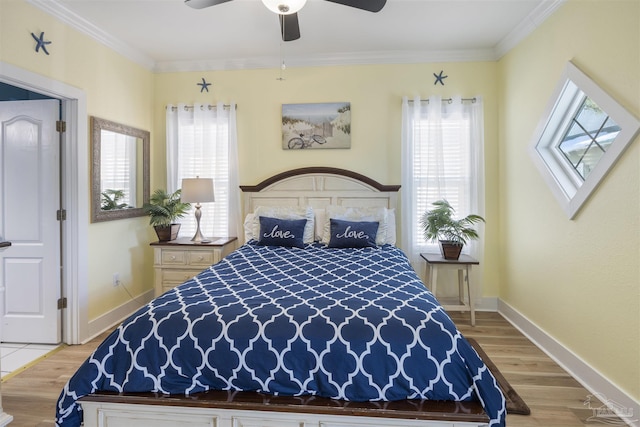 bedroom with crown molding, multiple windows, and light wood-type flooring