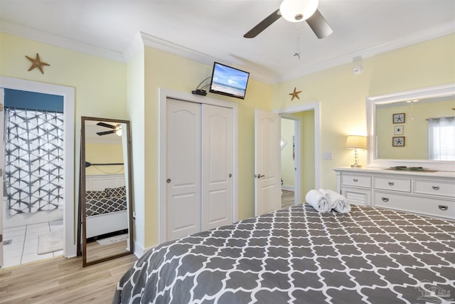 bedroom with connected bathroom, ornamental molding, ceiling fan, light hardwood / wood-style floors, and a closet