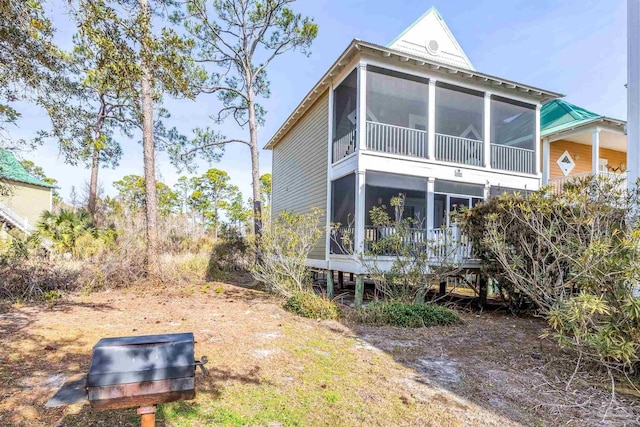 back of property featuring a sunroom