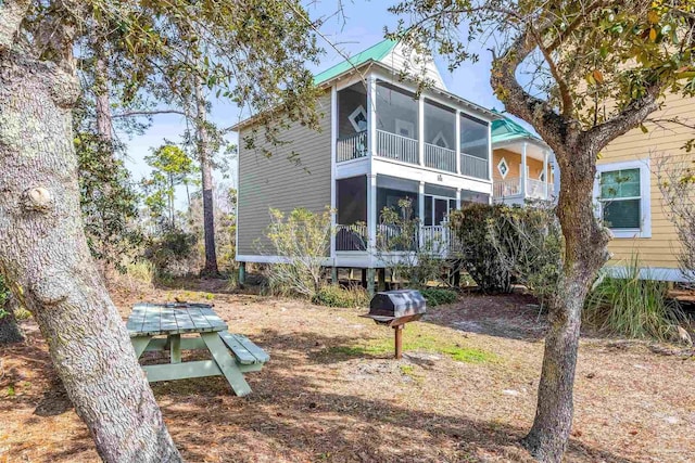 back of house with a sunroom