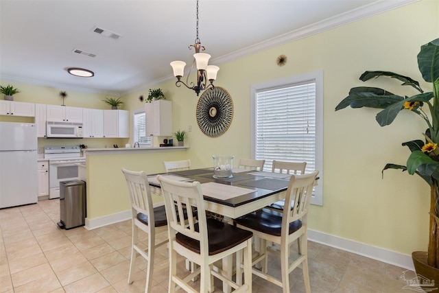 tiled dining area featuring crown molding and an inviting chandelier