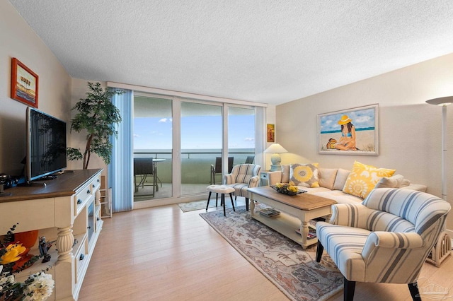 13753 Perdido Key Dr Unit 504, Perdido Key, FL 32507 - living area featuring a textured ceiling, a wall of windows, and light wood-style flooring