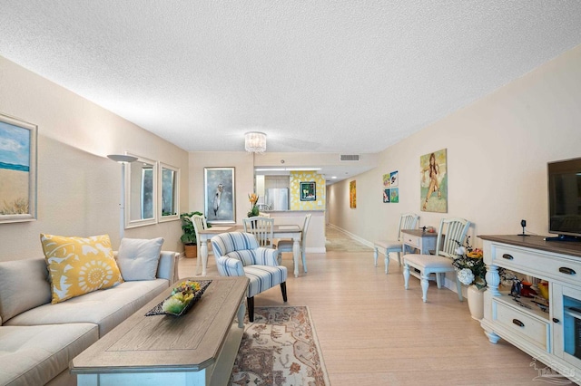 13753 Perdido Key Dr Unit 504, Perdido Key, FL 32507 - living area featuring light wood-style flooring, a textured ceiling, and baseboards