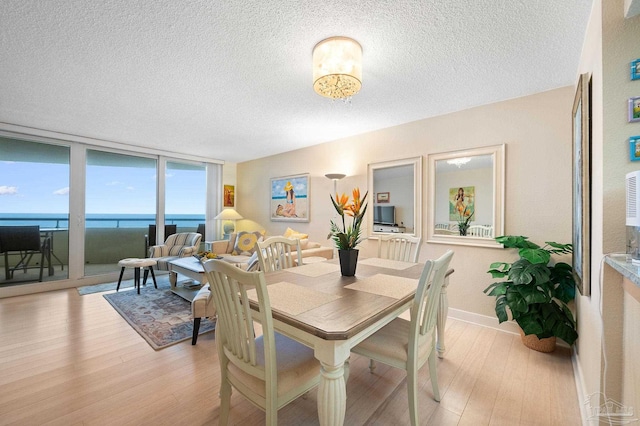 13753 Perdido Key Dr Unit 504, Perdido Key, FL 32507 - dining room with a textured ceiling, light wood finished floors, and floor to ceiling windows