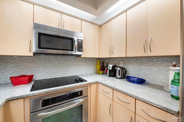 13753 Perdido Key Dr Unit 504, Perdido Key, FL 32507 - kitchen featuring appliances with stainless steel finishes, light brown cabinetry, tasteful backsplash, and light stone counters