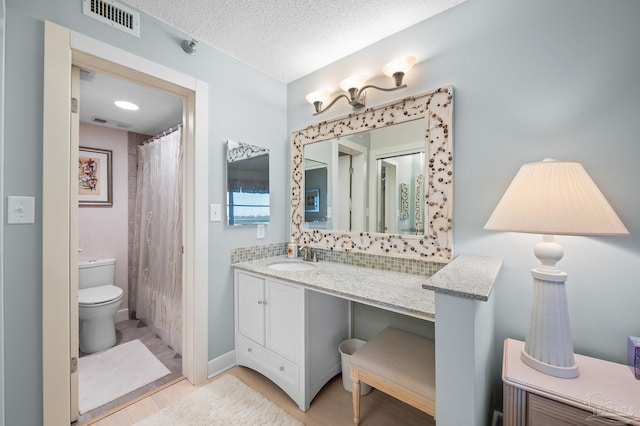 13753 Perdido Key Dr Unit 504, Perdido Key, FL 32507 - full bathroom featuring wood finished floors, toilet, vanity, and a textured ceiling