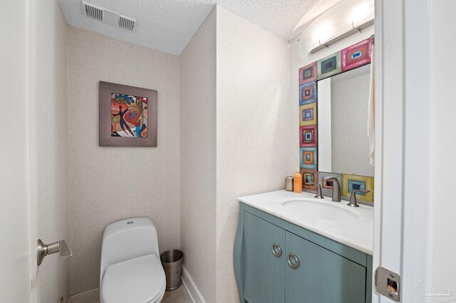 13753 Perdido Key Dr Unit 504, Perdido Key, FL 32507 - half bathroom with vanity, toilet, a textured ceiling, and baseboards