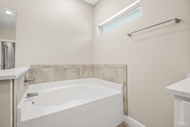 bathroom with a bathtub and vanity