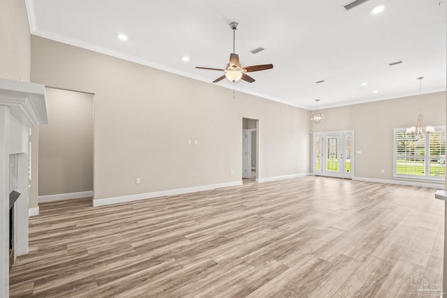 unfurnished living room with ceiling fan with notable chandelier, light wood-style flooring, and crown molding