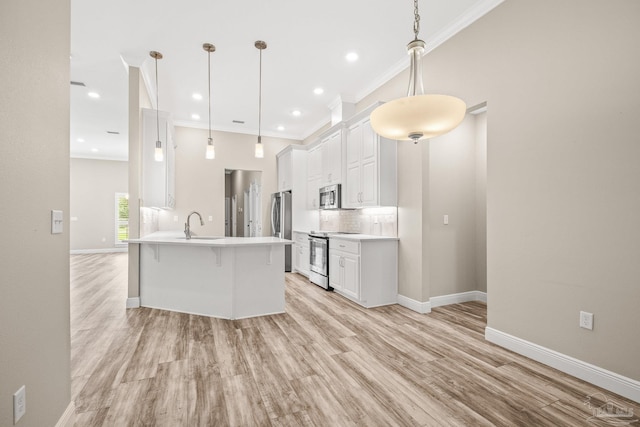 kitchen featuring light wood-type flooring, white cabinets, stainless steel appliances, decorative light fixtures, and crown molding