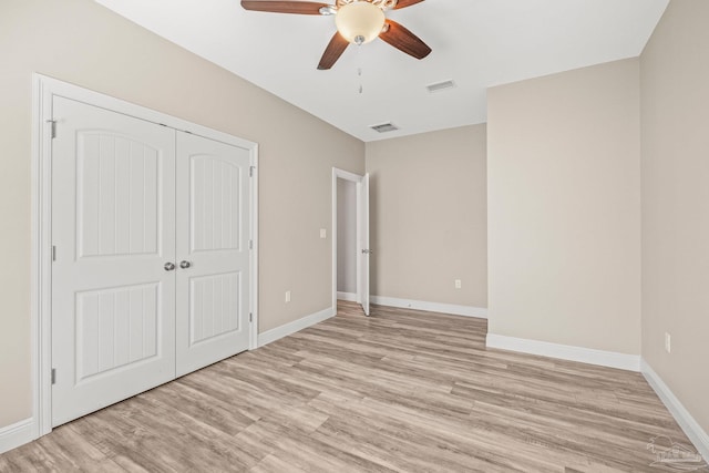 unfurnished bedroom featuring ceiling fan, light hardwood / wood-style flooring, and a closet