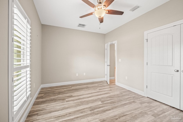 unfurnished bedroom featuring ceiling fan, a closet, and light hardwood / wood-style floors