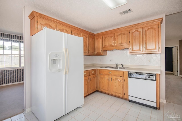 kitchen featuring a textured ceiling, sink, and white appliances