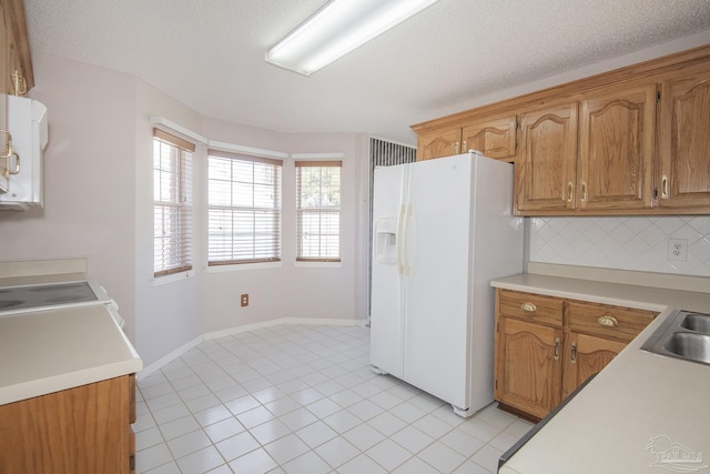 4416 Bellwood Cir, Pace, FL 32571 - kitchen featuring light countertops, white fridge with ice dispenser, light tile patterned floors, and tasteful backsplash