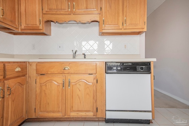 kitchen with light tile patterned flooring, tasteful backsplash, dishwasher, and a textured ceiling