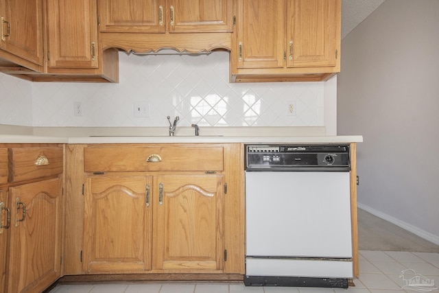 4416 Bellwood Cir, Pace, FL 32571 - kitchen with white dishwasher, light tile patterned floors, light countertops, backsplash, and baseboards