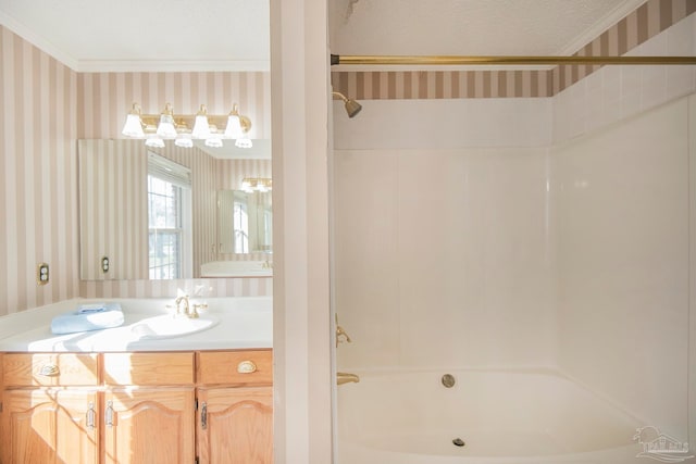 bathroom featuring vanity, a textured ceiling, shower / bathing tub combination, and ornamental molding