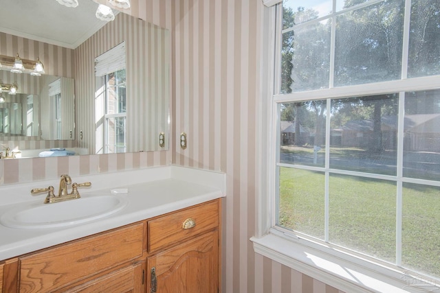 bathroom with vanity and ornamental molding