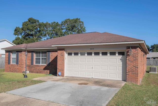 ranch-style house featuring a front yard, central AC, and a garage