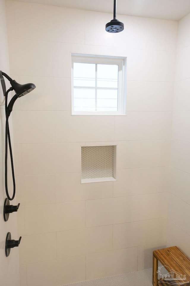 room details featuring a tile shower