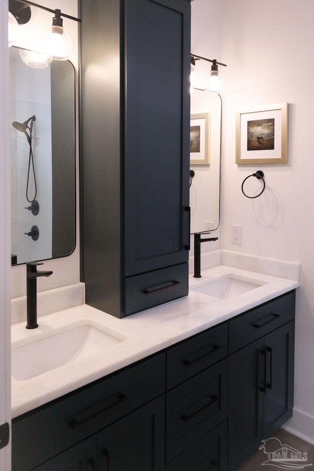 bathroom featuring a sink and double vanity