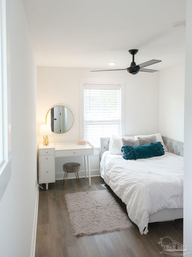 bedroom with baseboards, a ceiling fan, and wood finished floors