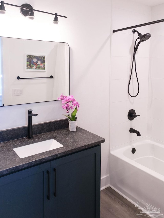 bathroom featuring vanity, shower / tub combination, and wood finished floors