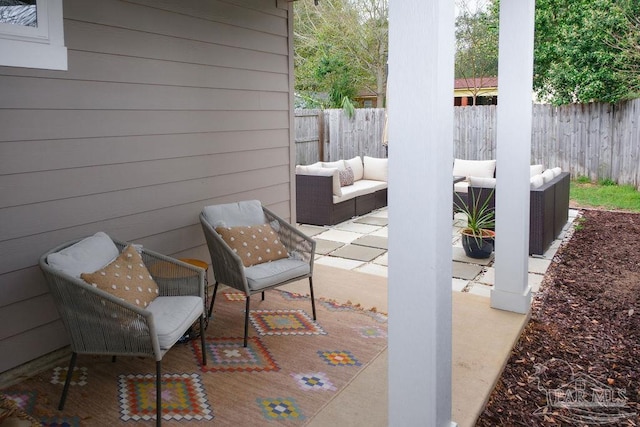 view of patio / terrace with an outdoor living space and fence