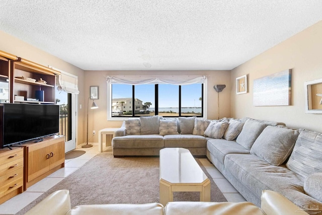 living room featuring light tile patterned floors and a textured ceiling