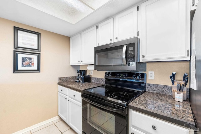 kitchen featuring white cabinetry, light tile patterned floors, and stainless steel appliances