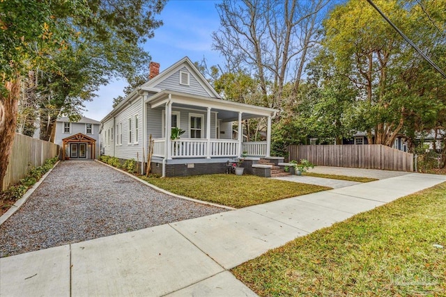 view of front of house with a porch and a front yard