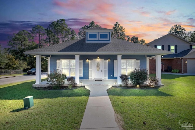 bungalow-style house with a lawn and a porch