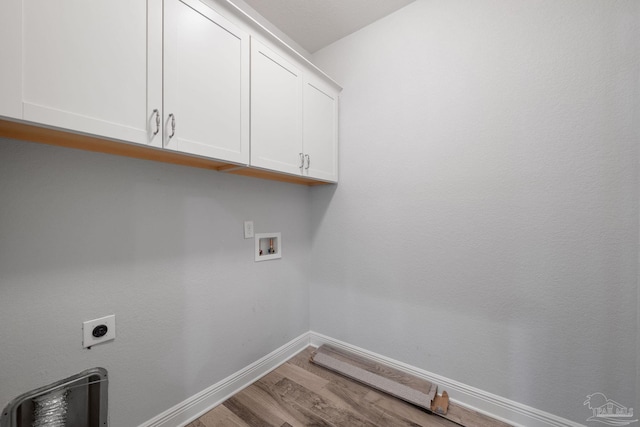 laundry area with cabinets, hookup for an electric dryer, hookup for a washing machine, and light hardwood / wood-style floors