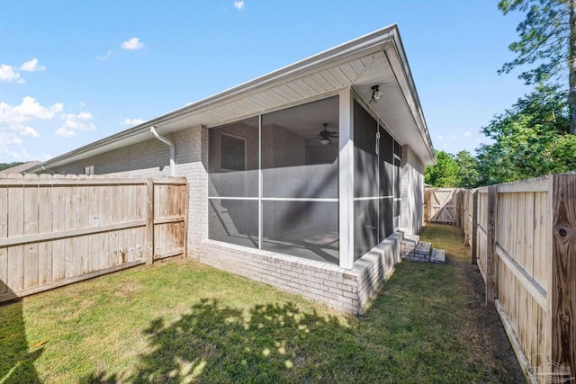 exterior space with a sunroom and a lawn