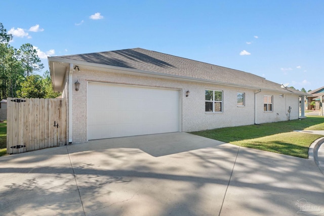 view of property exterior featuring a garage and a lawn