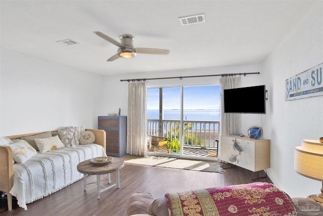 living room with ceiling fan and dark wood-type flooring