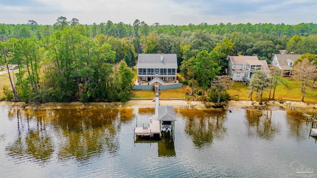 dock area featuring a water view and a wooded view