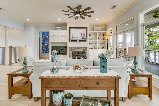 living room featuring visible vents, ornamental molding, french doors, a brick fireplace, and recessed lighting