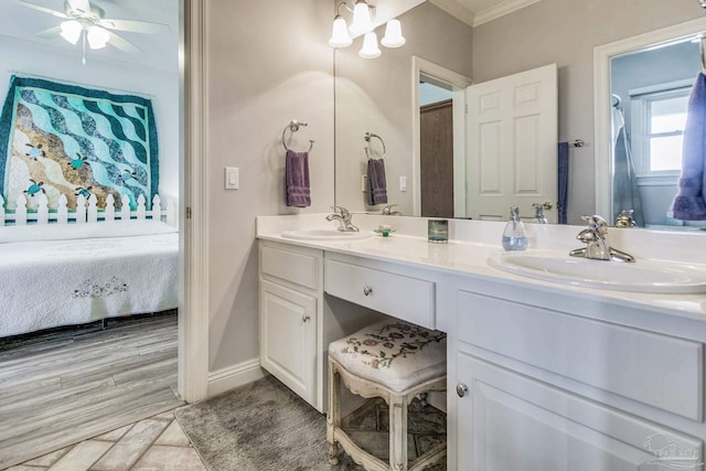 ensuite bathroom featuring crown molding, double vanity, a sink, and ensuite bathroom