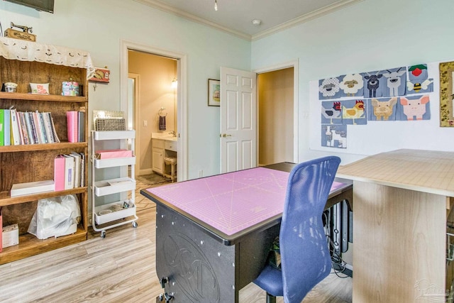 office space with light wood-type flooring and crown molding