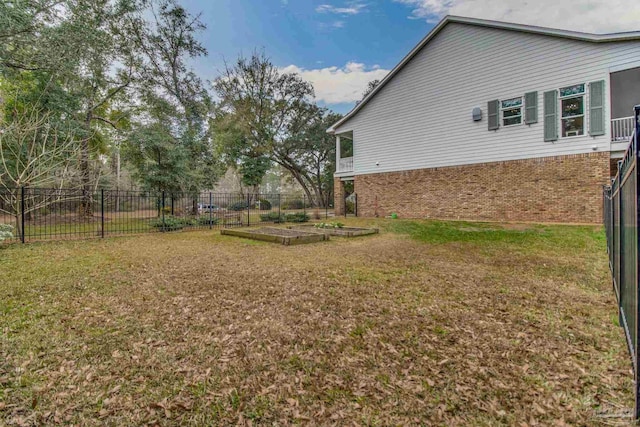 view of yard featuring a vegetable garden and fence