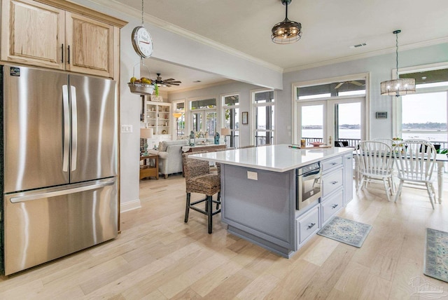 kitchen featuring french doors, light wood-style flooring, appliances with stainless steel finishes, open floor plan, and a kitchen island