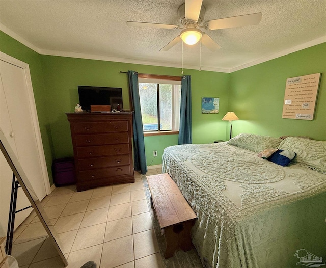 bedroom featuring crown molding, light tile patterned floors, and a textured ceiling